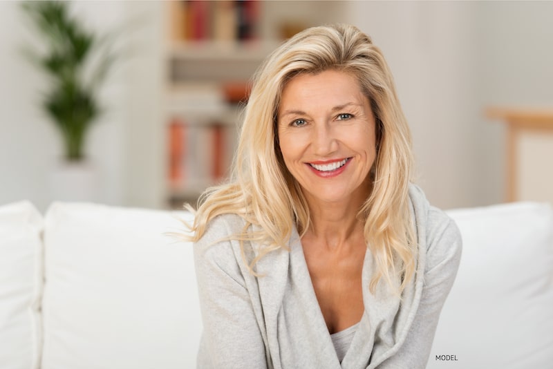 Woman sitting at home, relaxing on the couch.