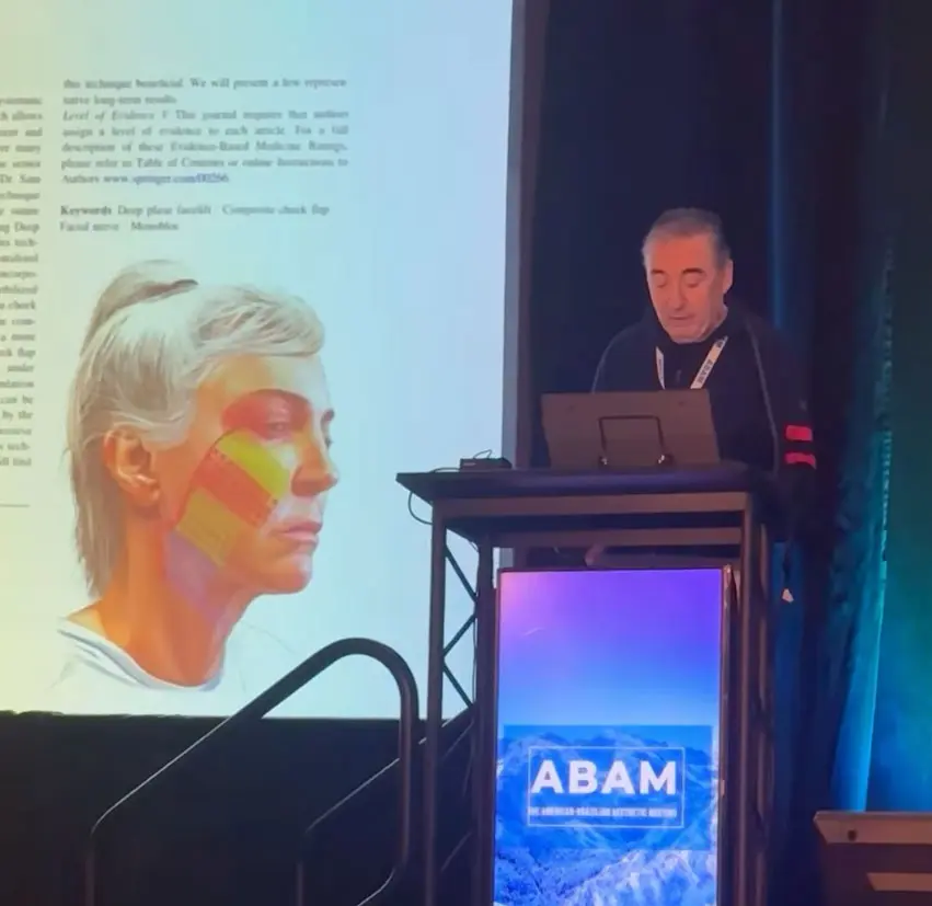 Dr Boris M Ackerman MD presenting at ABAM conference with thermal imaging slide of human head displayed on screen