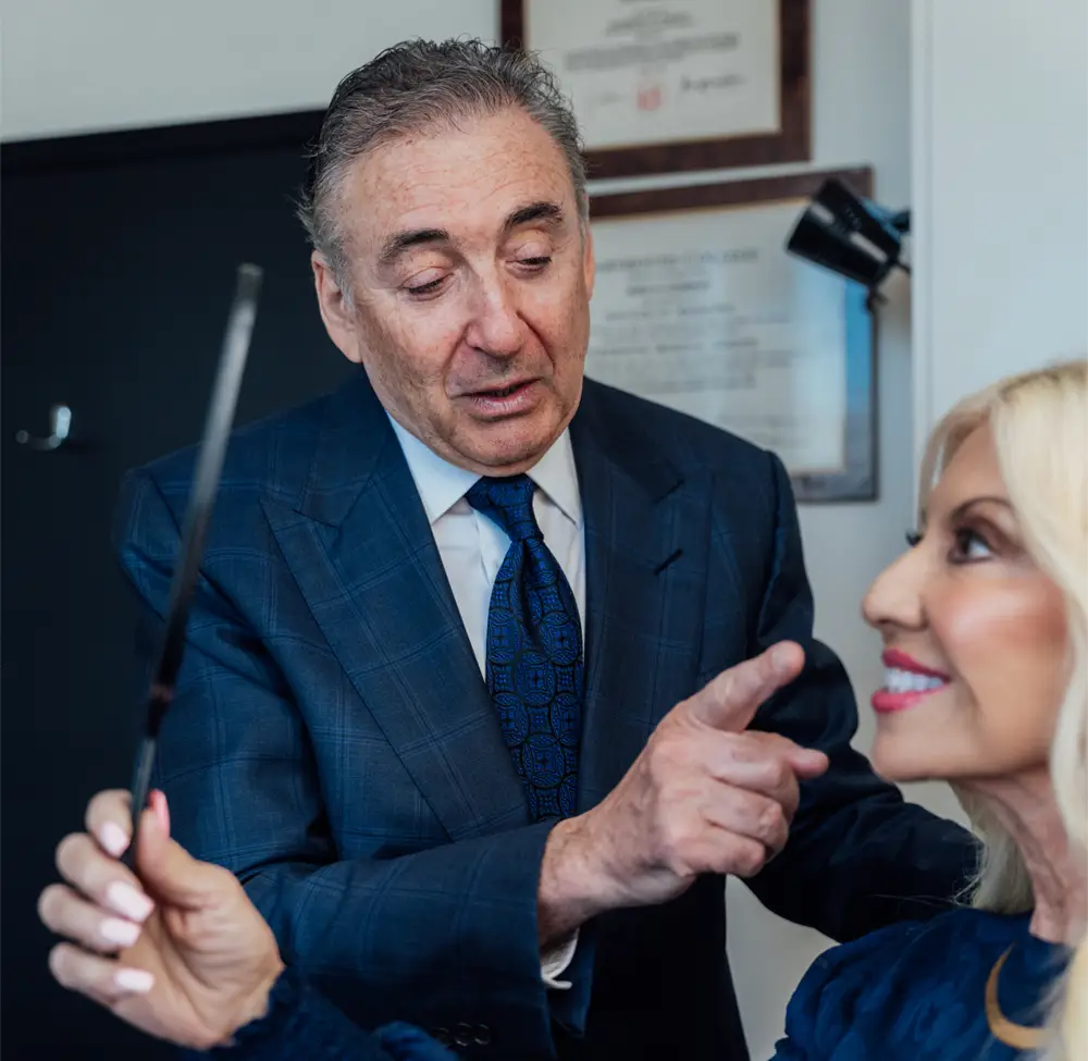Boris M. Ackerman, MD consulting with female patient about facial procedure in medical office - Expect in Newport Beach, CA