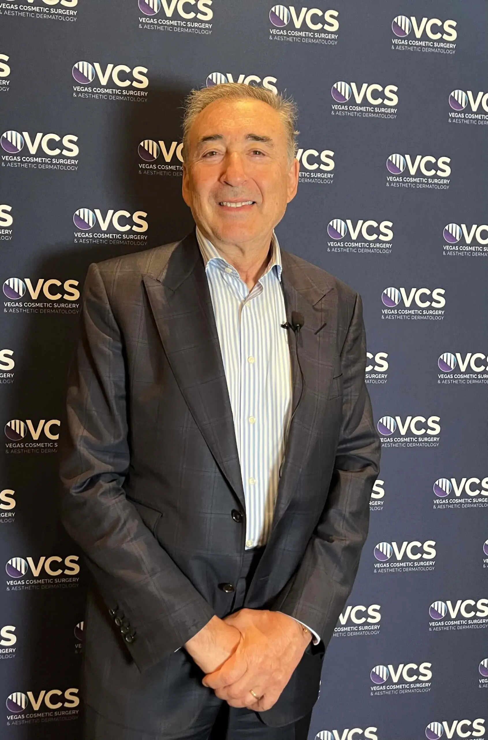 Dr Boris M Ackerman MD in suit at VCS corporate event backdrop