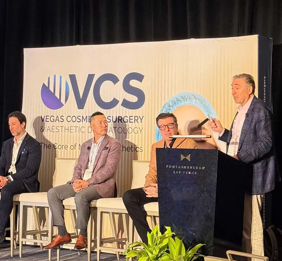 Panel discussion at NVCS Kansas Cosmetic Surgery Conference with speakers on stage and attendees