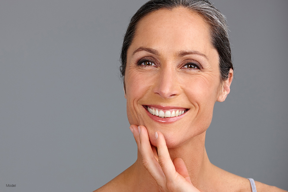 Mature woman touching her face